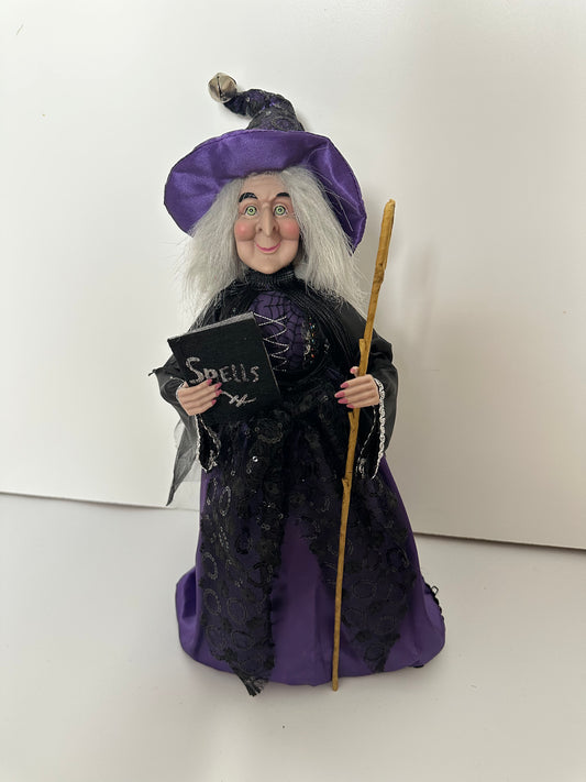 Witch with Purple Dress and Book of Spells
